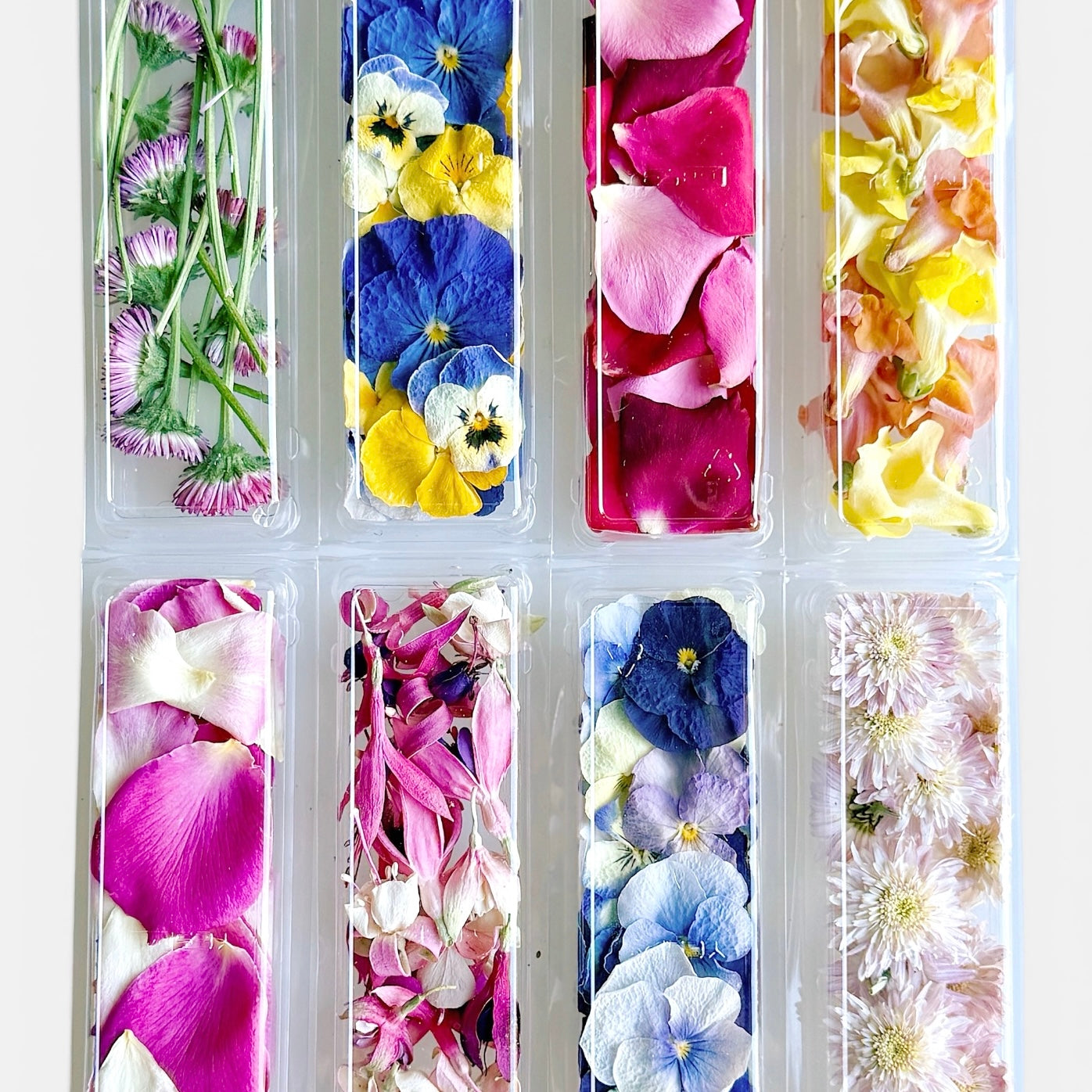 Vibrant set of 8 tubes of petite freeze dried edible flowers.