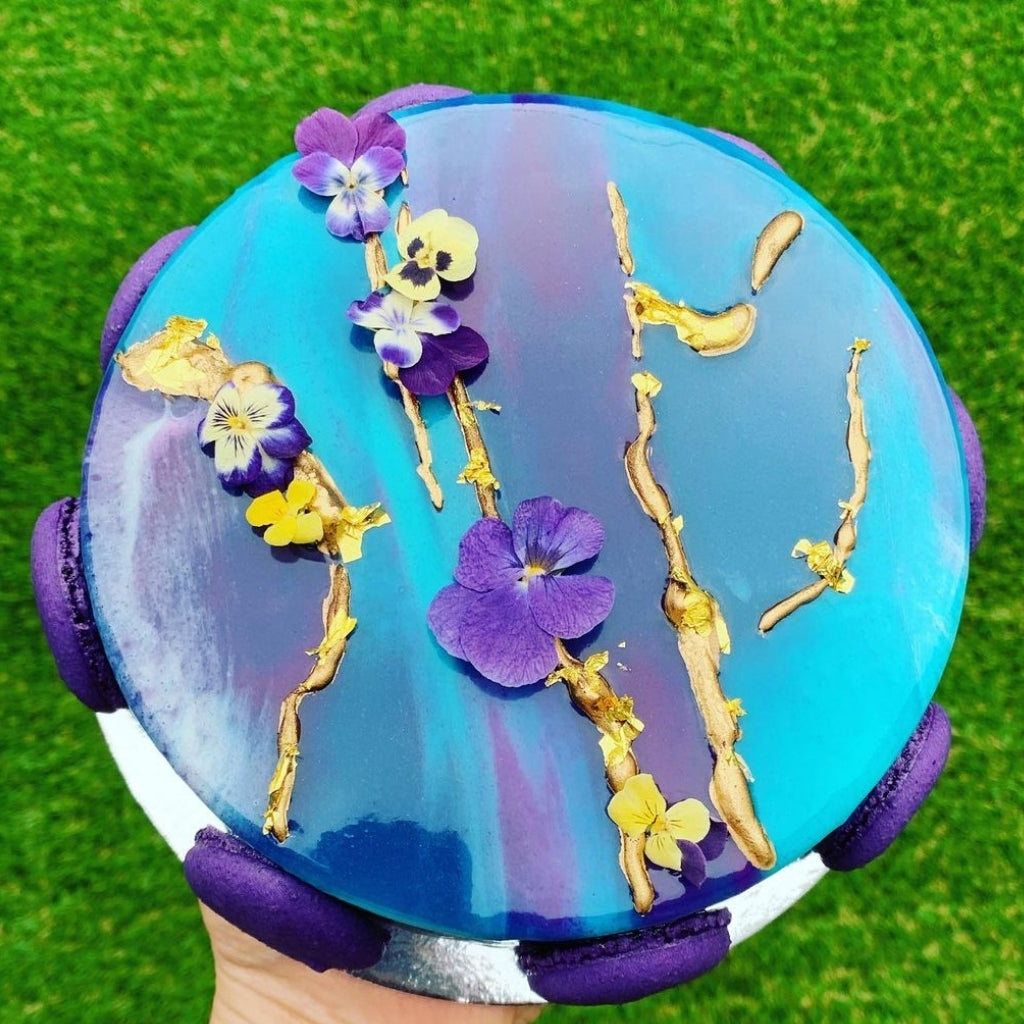 Caramel Snickers Brownie Entremet with Bloomish Violas by Polypop Patisserie.