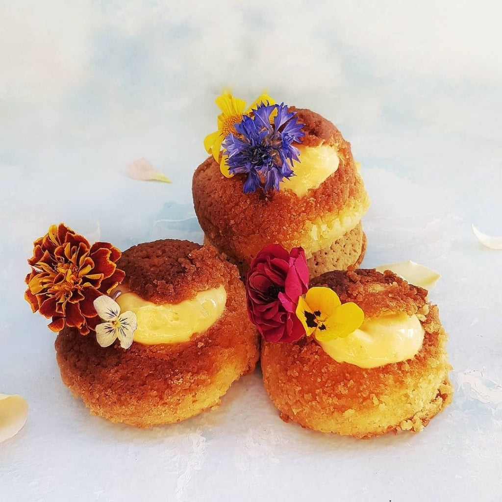 Luscious lemon cream puffs by @thenysehng, decorated with Bloomish freeze dried edible marigolds.
